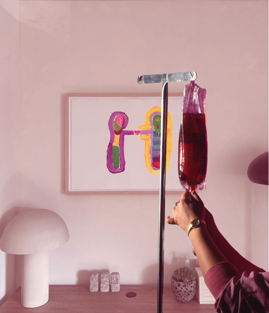 IV drip therapy bag being prepared in a calming treatment room with soft lighting and colorful abstract artwork.