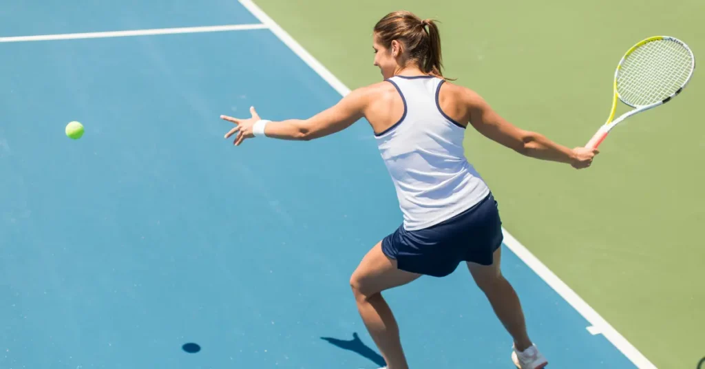 IV therapy for athletes supports peak performance, illustrated by a woman playing tennis on a blue and green court.
