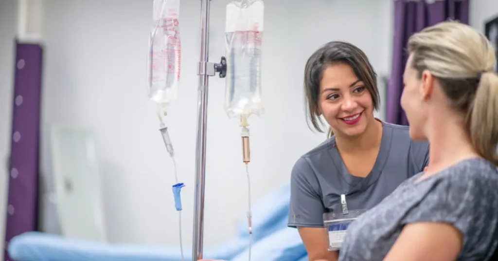 IV therapy for energy being administered by a nurse to a smiling patient in a clinical setting