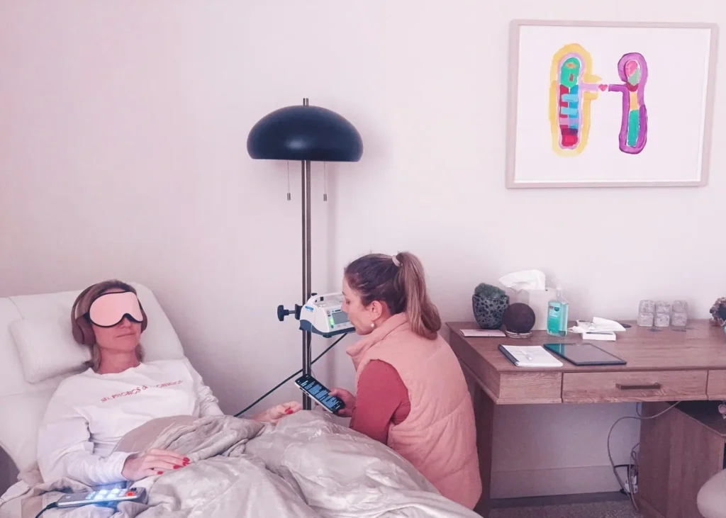 IV therapy for depression shown with a patient in bed and a therapist monitoring the infusion process.
