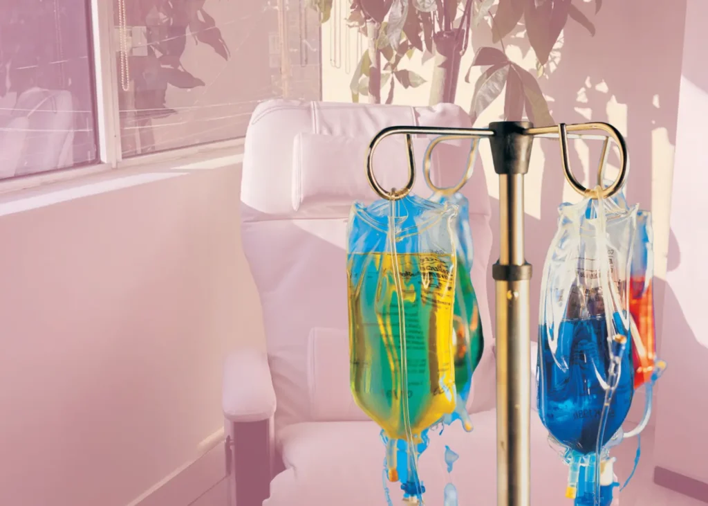 Psychedelic depression treatment setup with colorful IV bags in a bright, modern therapy room.