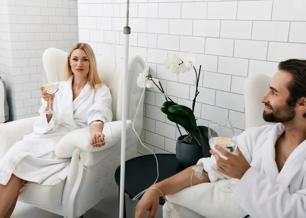 Depression treatments with two patients in robes receiving IV infusions while relaxing in comfortable chairs.
