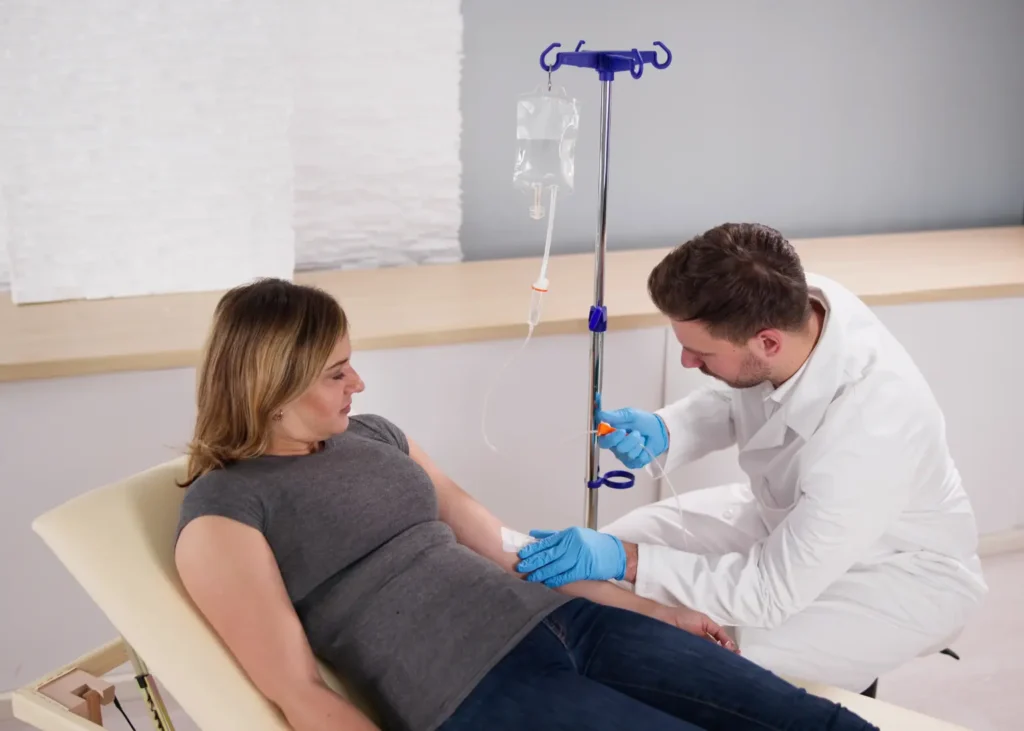 Ketamine drip for depression being carefully managed by a doctor for a reclining patient in a clinic.